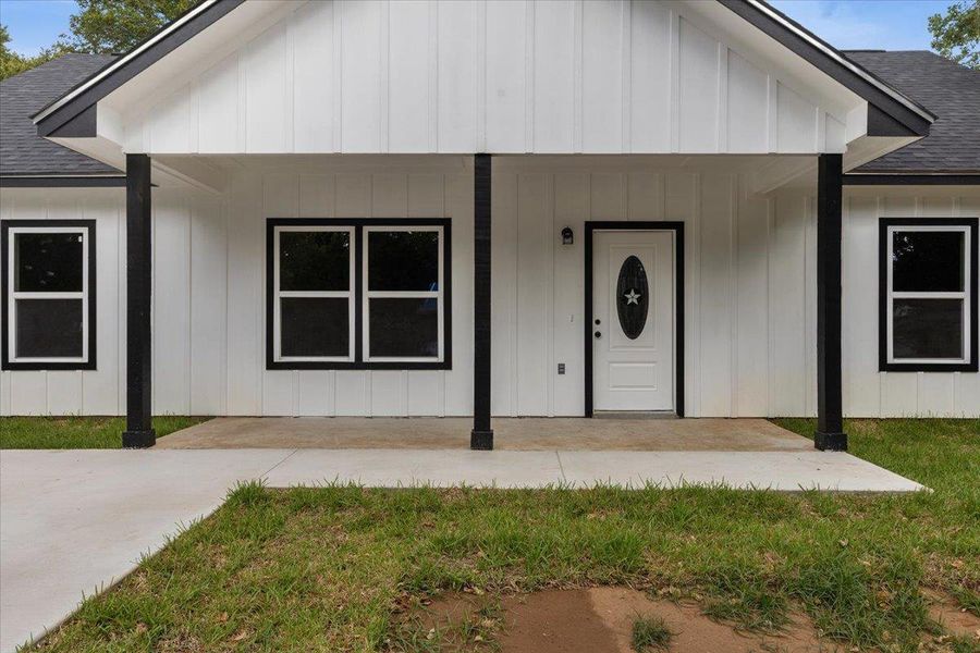 Crisp white board and batten siding pairs with black trim for modern farmhouse curb appeal. Crisp white board and batten siding pairs with black trim for modern farmhouse curb appeal.