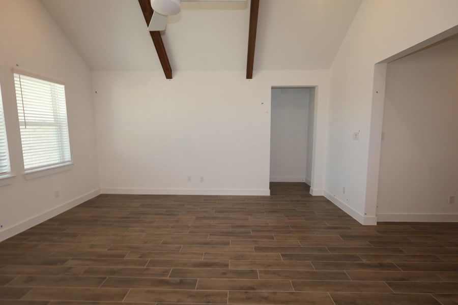 Open great room with vaulted ceilings and stained beams