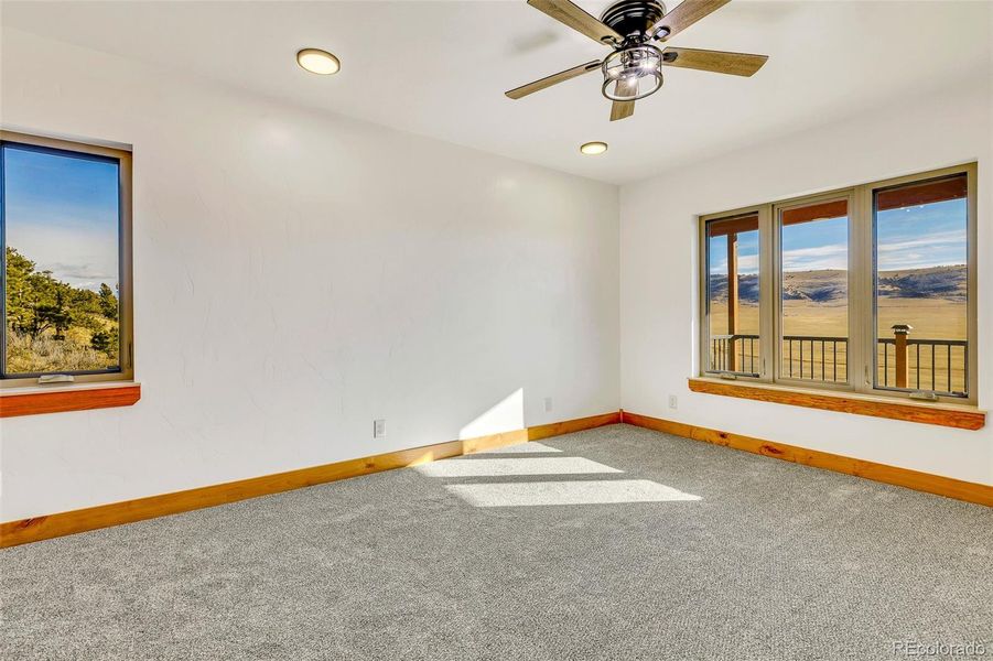 Main level primary bedroom with a view from every window!