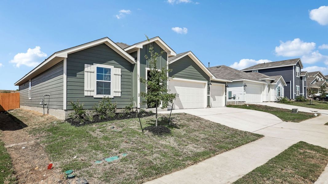 Front exterior of a new home in Prairie Lakes, Buda, TX, highlighting curb appeal (Image 23).