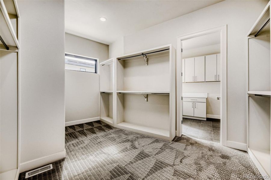 Primary closet with access to laundry area