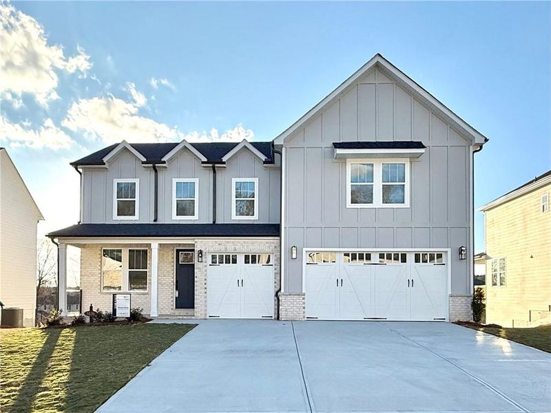 Front exterior of a new home in , Braselton, GA, highlighting curb appeal (Image 1).