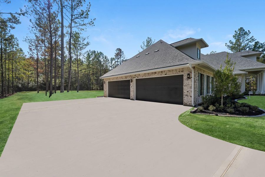 Long driveway leading to an oversized 4-car garage, offering ample parking and exceptional convenience for multiple vehicles or storage needs. Long driveway leading to an oversized 4-car garage, offering ample parking and exceptional convenience for multiple vehicles or storage needs.