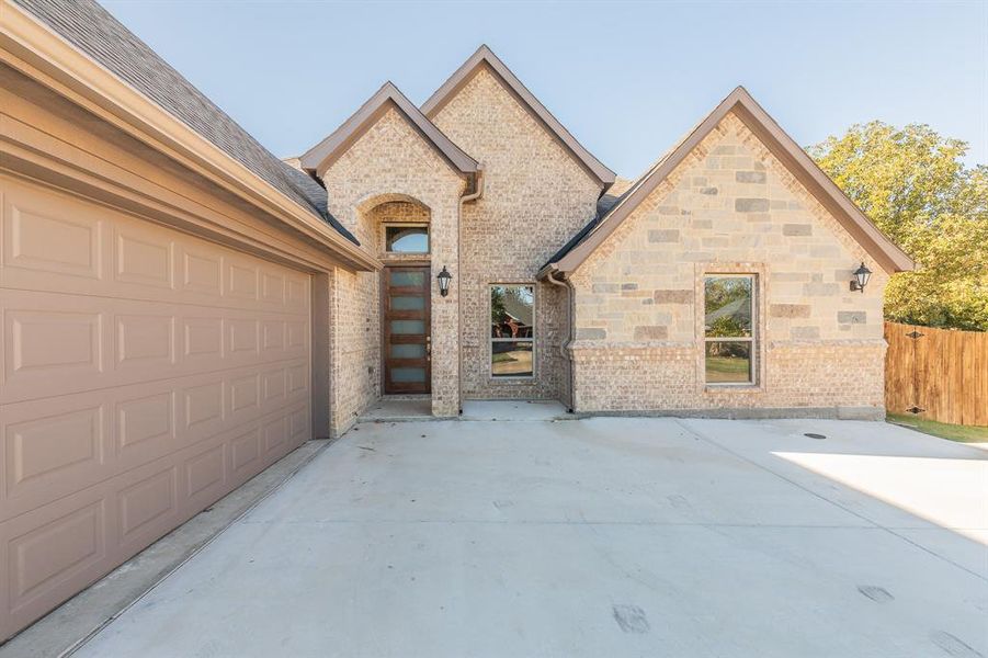 View of front facade featuring a garage