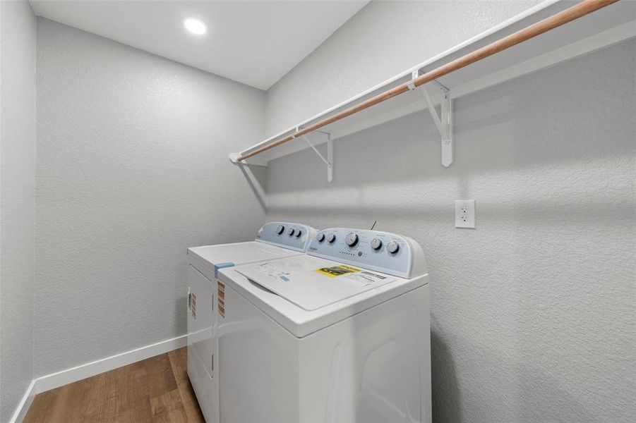 Laundry room featuring washing machine and clothes dryer, wood finished floors, and recessed lighting Laundry room featuring washing machine and clothes dryer, wood finished floors, and recessed lighting