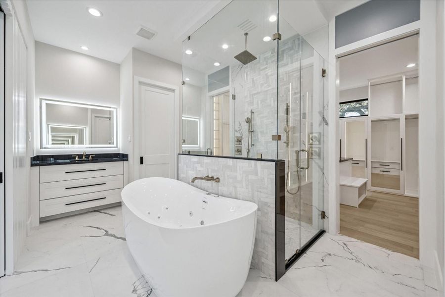 Alternate view showing the vanity accented by a sleek, modern lighted mirror bringing elegance and function to the space. Alternate view showing the vanity accented by a sleek, modern lighted mirror bringing elegance and function to the space.
