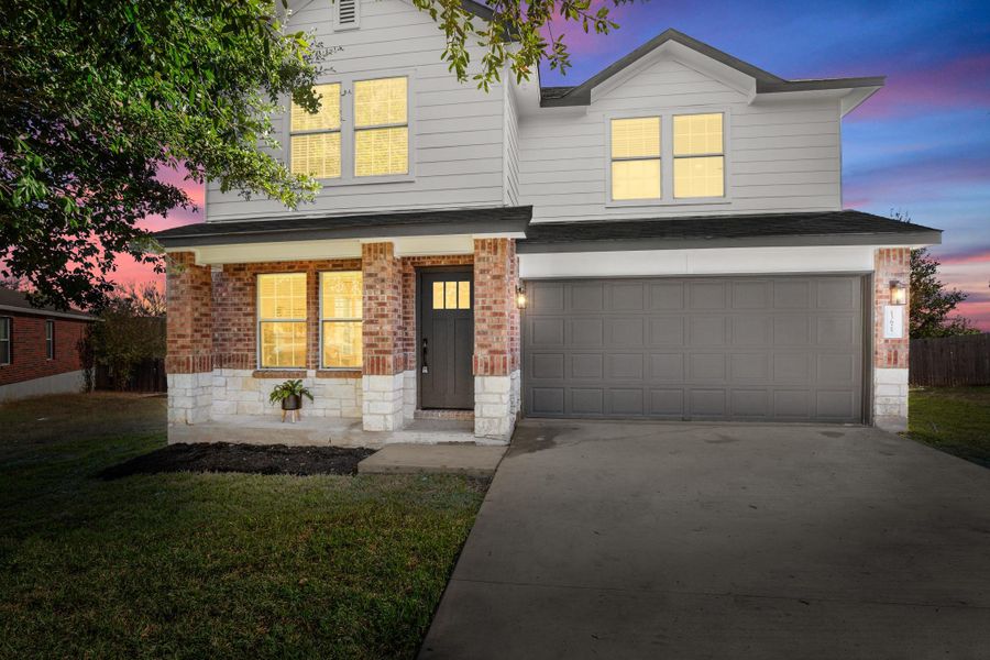 Front exterior of a new home in , Pflugerville, TX, highlighting curb appeal (Image 1).