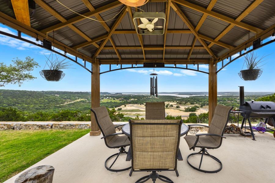 A covered patio offering panoramic views of the surrounding landscape and distant water features. A covered patio offering panoramic views of the surrounding landscape and distant water features.