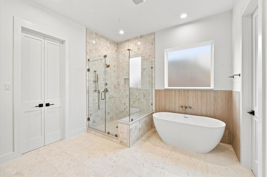 Primary bathroom features a large shower and a soaking tub.