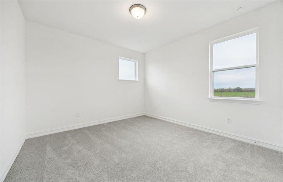 Spacious secondary bedroom with large windows  *Model Representation*