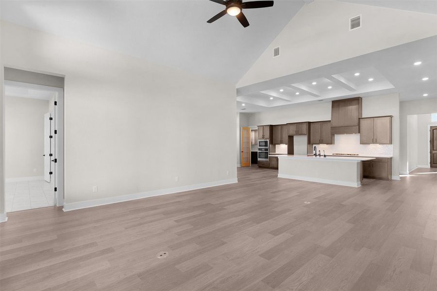 Unfurnished living room featuring recessed lighting, light wood-style flooring, high vaulted ceiling, and ceiling fan