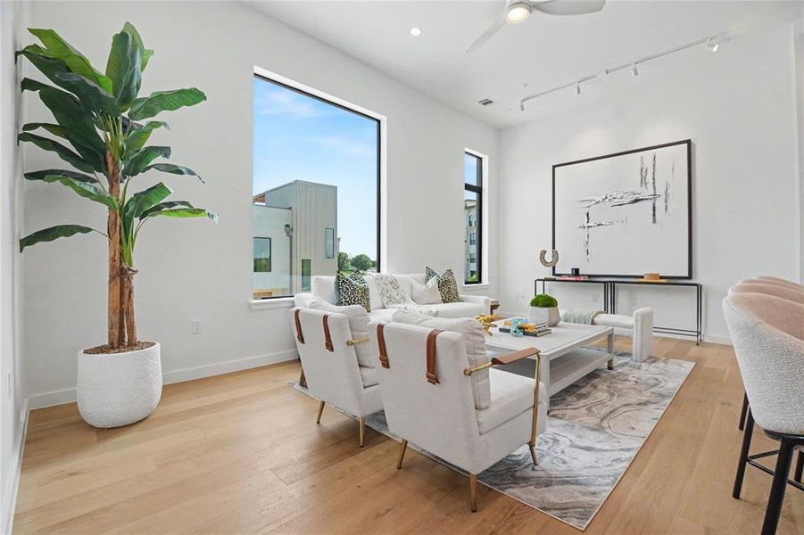 Tall ceilings and large windows flood the space with natural light.