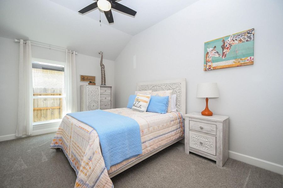 Vaulted ceiling secondary bedroom with walk-in closet