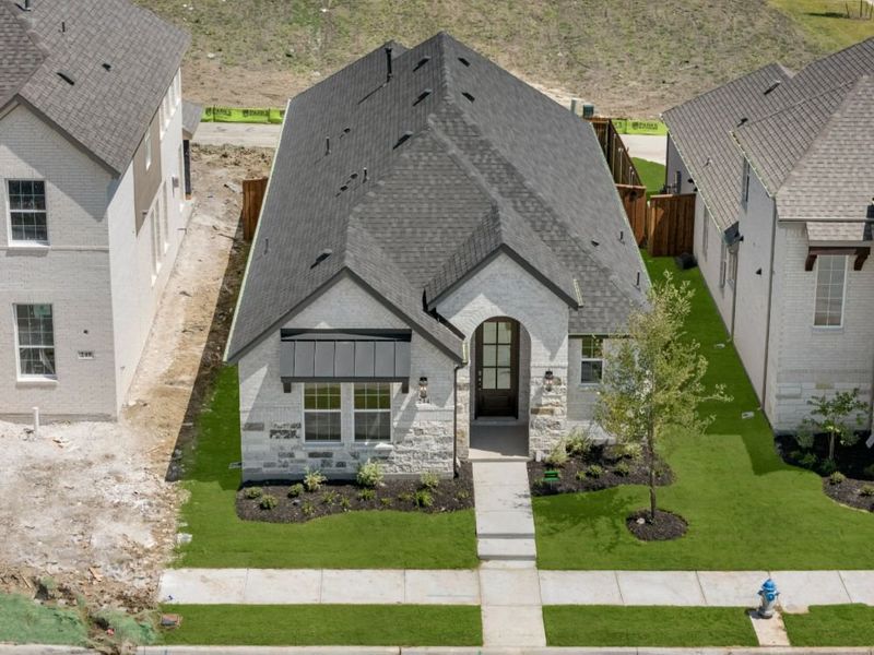 Representative exterior photo of a completed home built from the Cypress by UnionMain Homes in Edgewater, Fate, TX (Image 28).