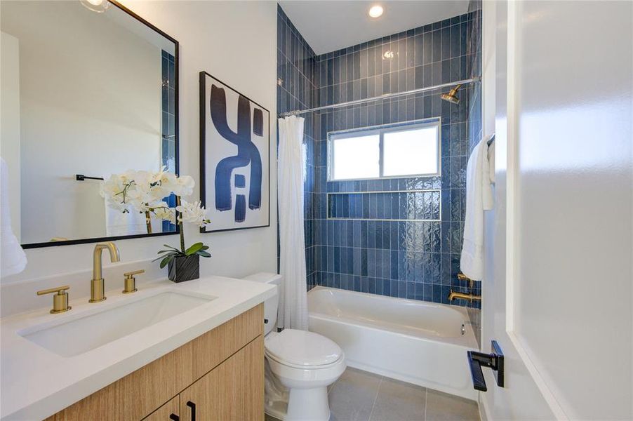 Custom tilework adorns the attached full bath for Bedroom 3.