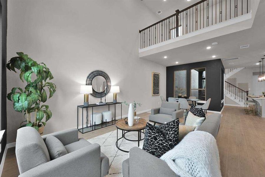 Seamless flow between living, dining, and kitchen with luxury vinyl plank flooring. (Original Builder Staged Photo 2024)