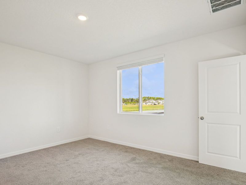 Spacious, unfurnished interior of a new home in The Grove at Stuart Crossing - Premier Series, Bartow (Image 12).