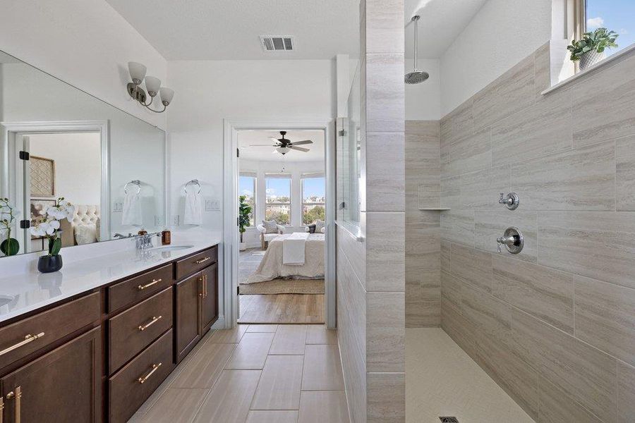 Ensuite bathroom with a walk in shower, double vanity, and ceiling fan Ensuite bathroom with a walk in shower, double vanity, and ceiling fan