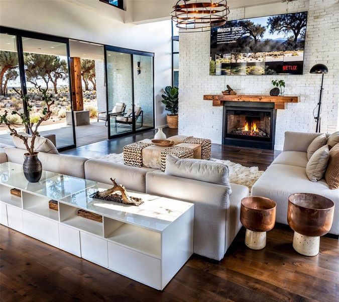 Living area featuring wood finished floors and a lit fireplace