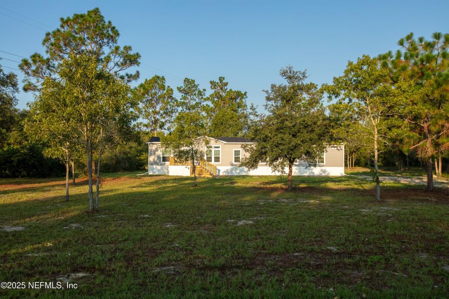 Front exterior of a new home in , Keystone Heights, FL, highlighting curb appeal (Image 23). Front exterior of a new home in , Keystone Heights, FL, highlighting curb appeal (Image 23).