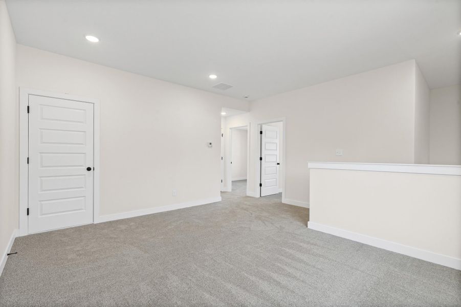 Carpeted spare room featuring baseboards and recessed lighting Carpeted spare room featuring baseboards and recessed lighting