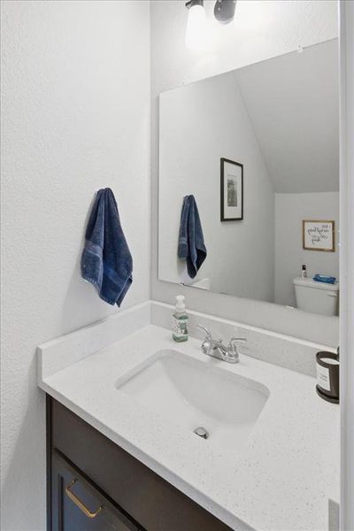 Half bath featuring a quartz vanity Half bath featuring a quartz vanity
