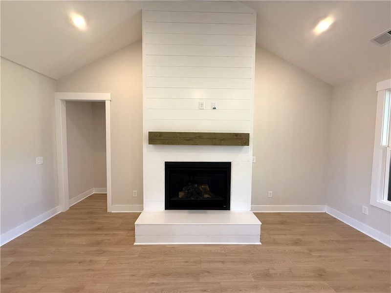 This inviting space features vaulted ceilings and
