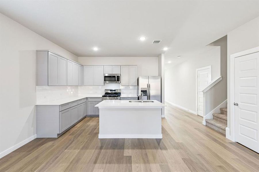 Kitchen in the Haylee home plan by Trophy Signature Homes - REPRESENTATIVE PHOTO