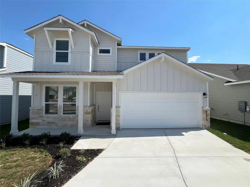 Front exterior of a new home in Wellspring, Hutto, TX, highlighting curb appeal (Image 20). Front exterior of a new home in Wellspring, Hutto, TX, highlighting curb appeal (Image 20).