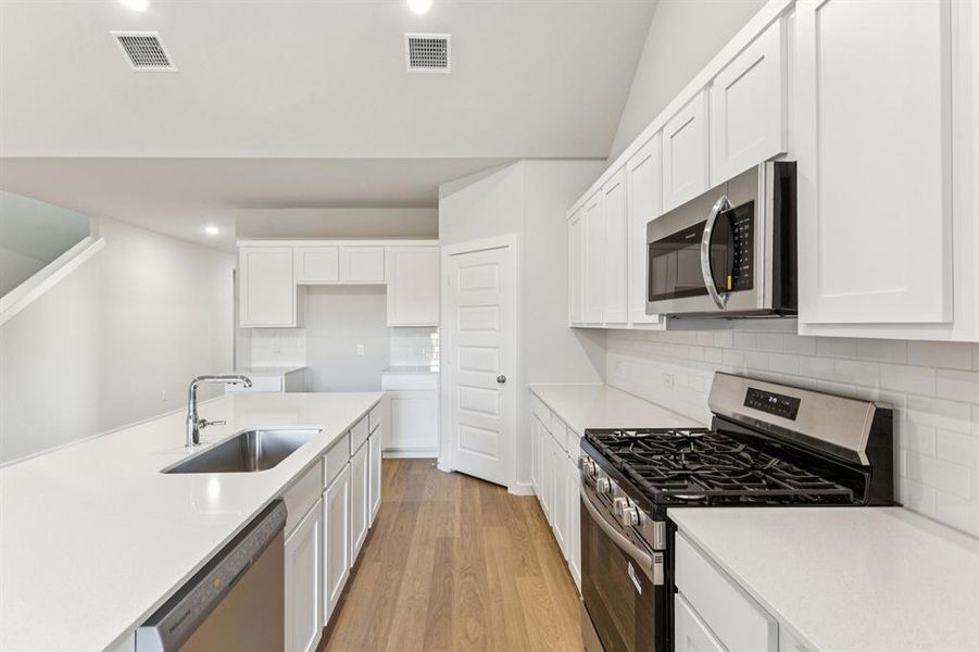 Kitchen in the Wimbledon home plan by Trophy Signature Homes – REPRESENTATIVE PHOTO