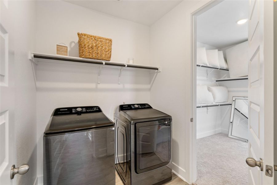 Enjoy easy access to the laundry room via the primary bedroom's walk-in closet.