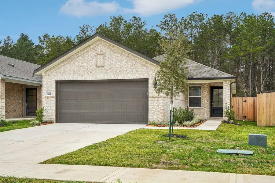 Front exterior of a new home in Landing Meadows - Traditional Series, New Caney, TX, highlighting curb appeal (Image 16).
