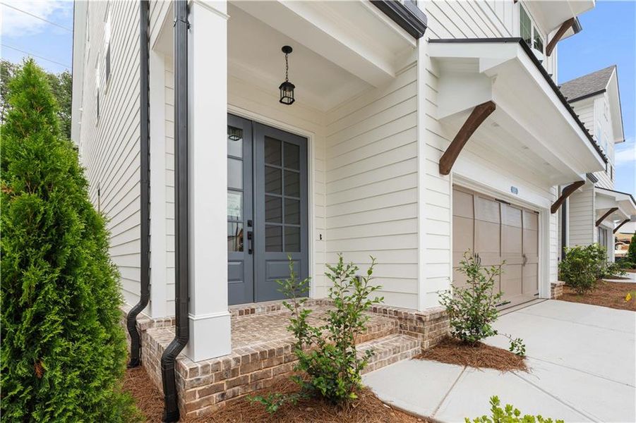 Front exterior of a new home in Palisades Single Family, Cumming, GA, highlighting curb appeal (Image 30).