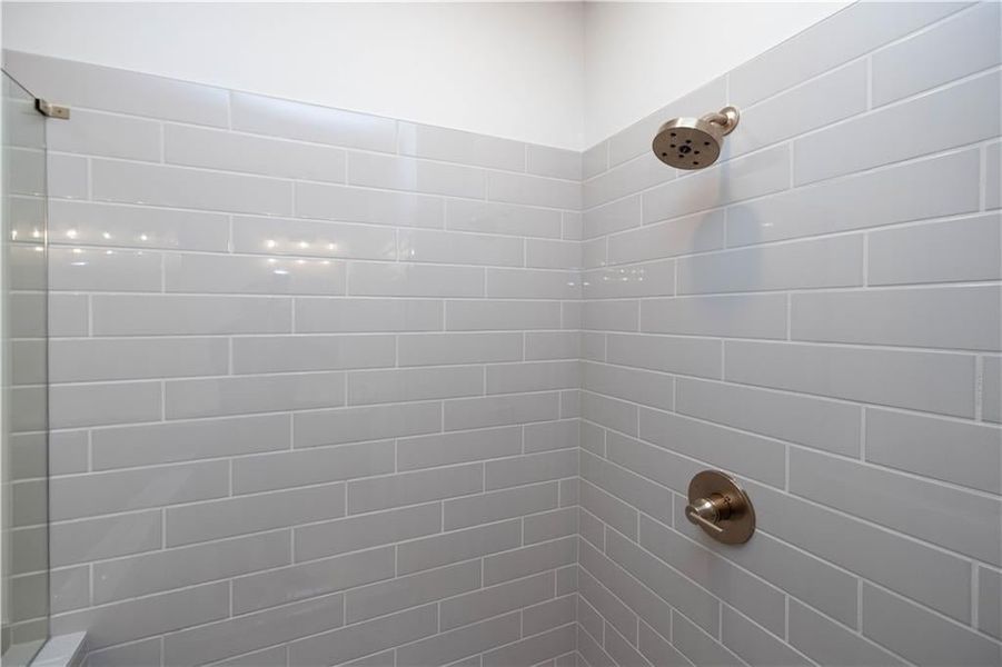 Bathroom featuring a tile shower