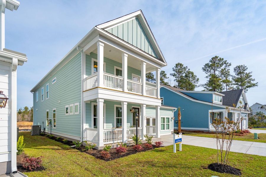 Front exterior of a new home in Tidewater at Lakes of Cane Bay, Summerville, SC, highlighting curb appeal (Image 1).