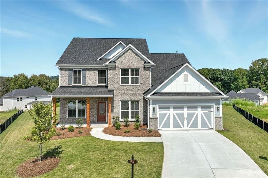Front exterior of a new home in Berkeley Mill, Cumming, GA, highlighting curb appeal (Image 25). Front exterior of a new home in Berkeley Mill, Cumming, GA, highlighting curb appeal (Image 25).