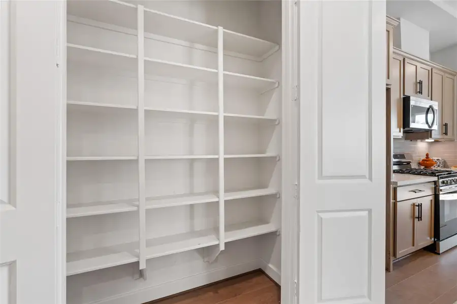 Reach-in pantry with full height shelving keeps dry goods and kitchen overflow organized and completely out of sight. Reach-in pantry with full height shelving keeps dry goods and kitchen overflow organized and completely out of sight.