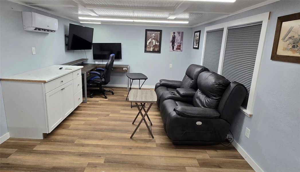 Home office with light wood-type flooring