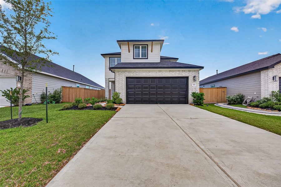 Front exterior of a new home in La Segarra, Brookshire, TX, highlighting curb appeal (Image 2). Front exterior of a new home in La Segarra, Brookshire, TX, highlighting curb appeal (Image 2).