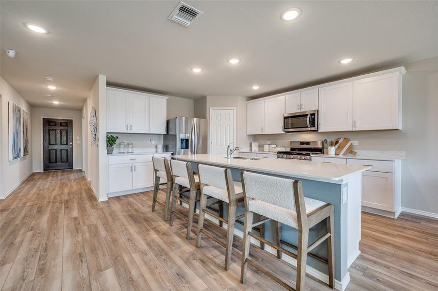 Spacious kitchen with eat-in bartop island *Model Representation*