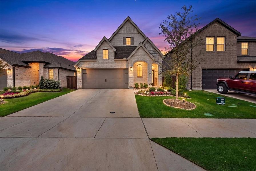 Light-colored brick and stone veneer exterior with a gabled roofline Light-colored brick and stone veneer exterior with a gabled roofline