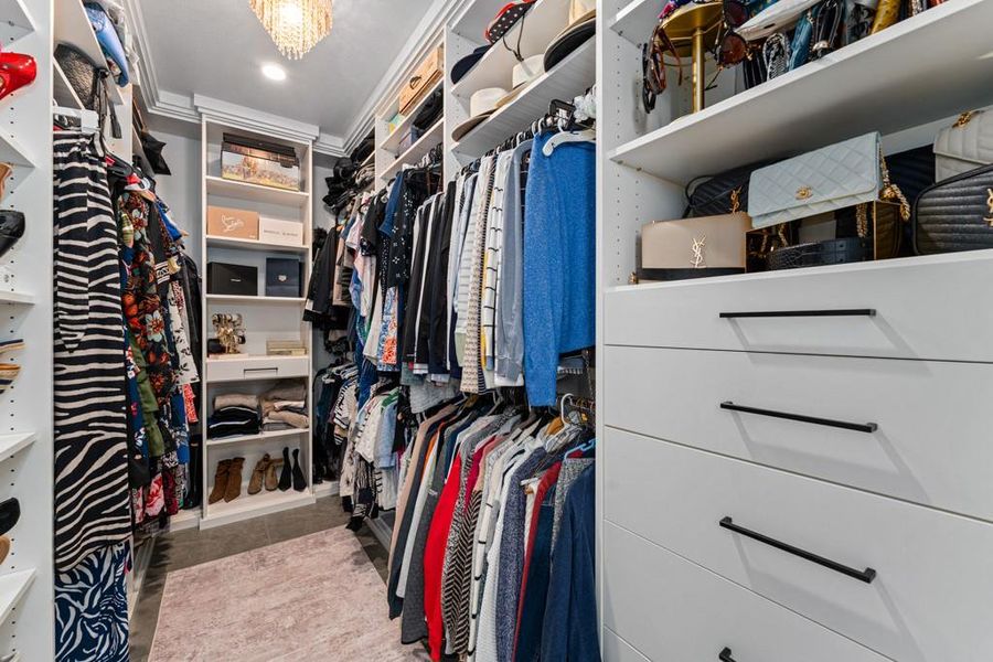 A well-organized walk-in closet offers extensive shelving and storage for a curated wardrobe. A well-organized walk-in closet offers extensive shelving and storage for a curated wardrobe.