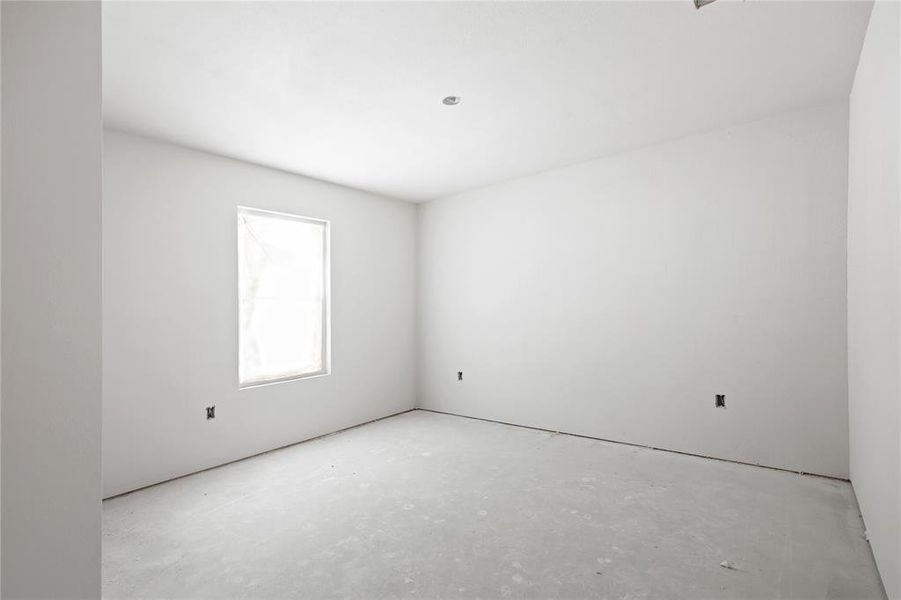 Room featuring a window, white walls, and a recessed light fixture