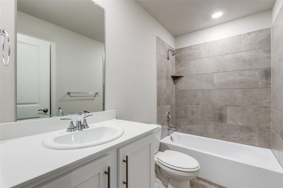 Full bath featuring shower / bath combination and vanity