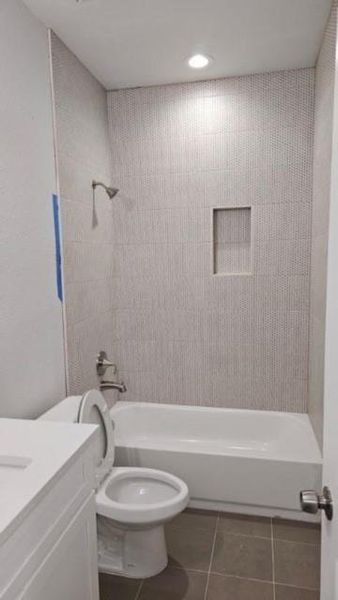 Full bathroom featuring toilet,  shower combination, tile patterned floors, and vanity