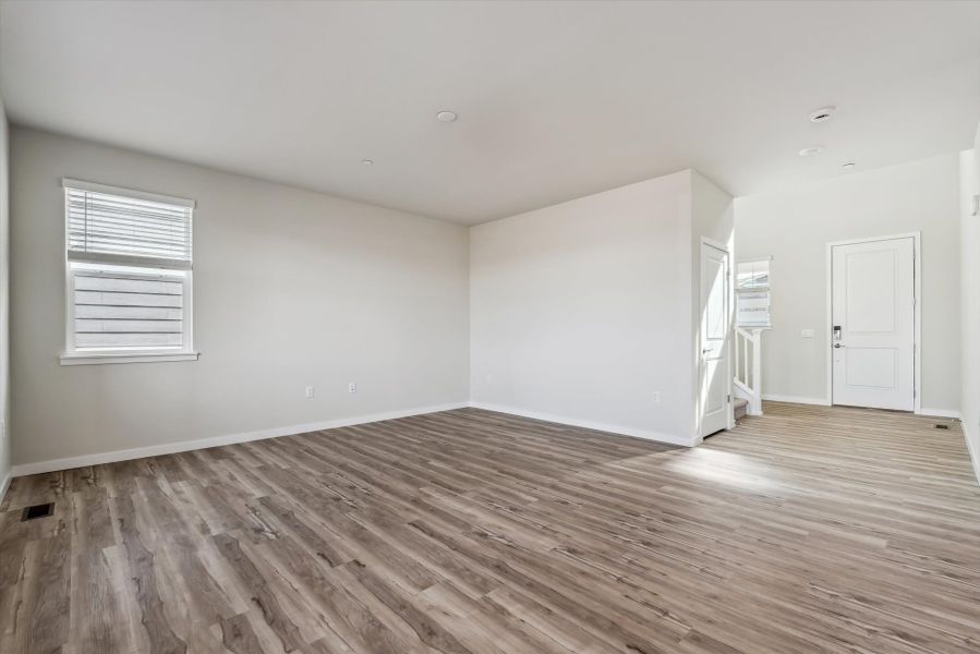 A room with a wood floor and white walls.