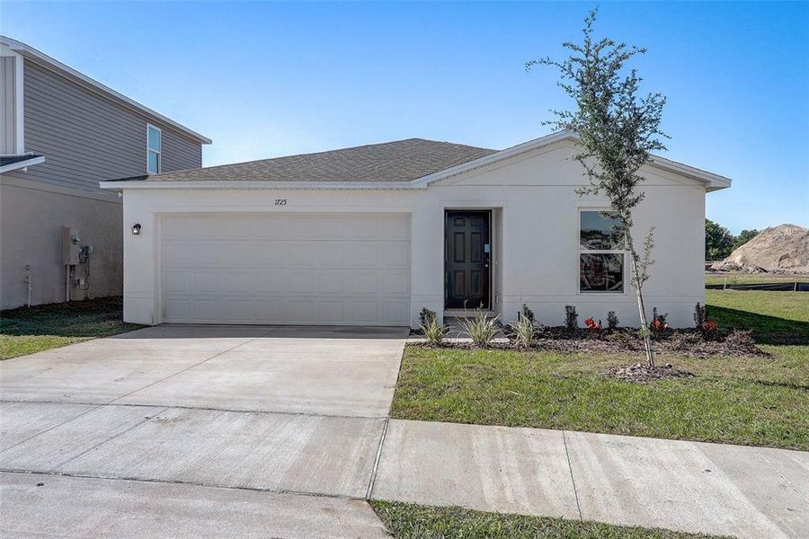 Front exterior of a new home in Lakewood Park, Fort Pierce, FL, highlighting curb appeal (Image 2). Front exterior of a new home in Lakewood Park, Fort Pierce, FL, highlighting curb appeal (Image 2).