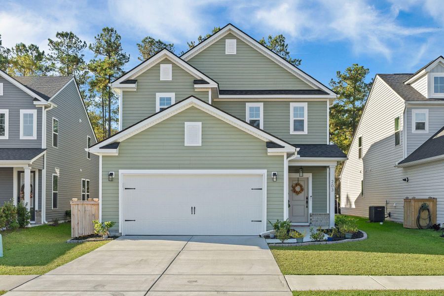 Front exterior of a new home in Jasmine Point at Lakes of Cane Bay, Summerville, SC, highlighting curb appeal (Image 2).