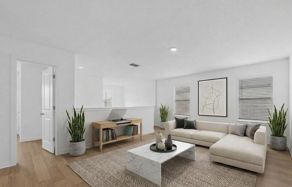 Living room featuring light wood-style flooring and recessed lighting