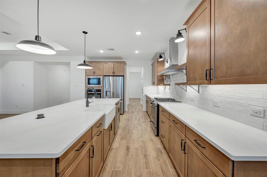 Stylish kitchen with chestnut brown cabinets and quartz counters